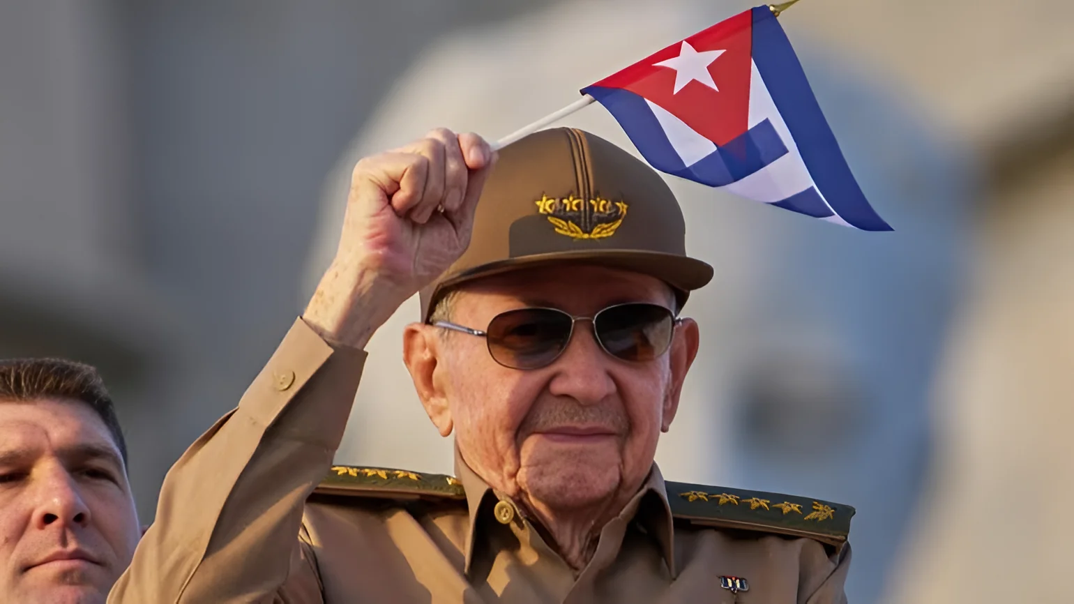 Raul Castro waves a Cuban national flag during a May Day parade at Revolution Square in Havana on May 1, 2025. Credit: AP/Ramon Espinosa