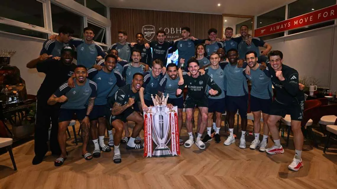 Arsenal players celebrate winning the Premier League after Manchester City's draw with Bournemouth. Stuart MacFarlane/Arsenal FC via Getty Images