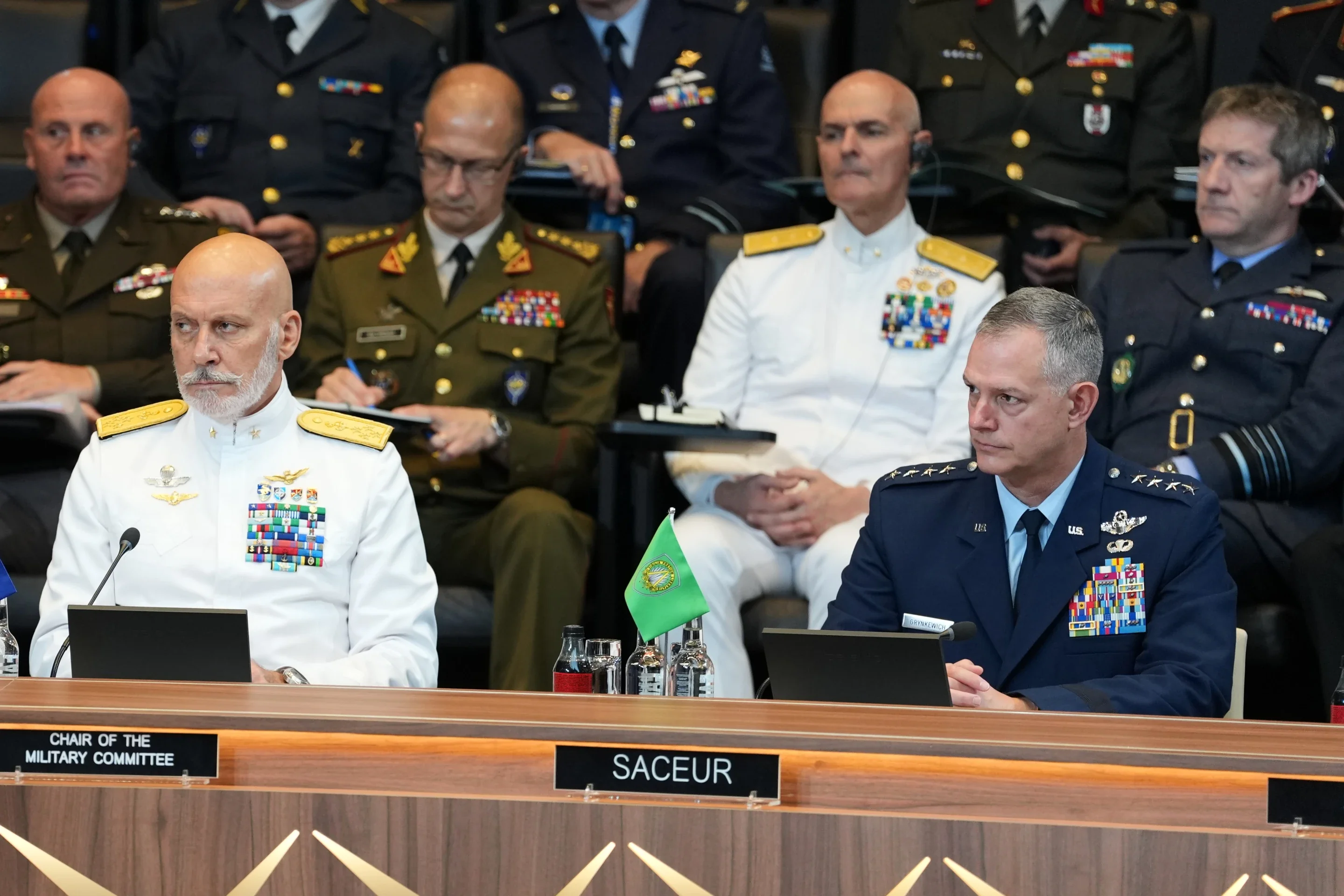 NATO’s Supreme Allied Commander Europe General Alexus Grynkewich, front right, and Chair of the NATO Military Committee Admiral Giuseppe Cavo Dragone, front left, listen to a speech by United States Defense Secretary Pete Hegseth during a meeting of the North Atlantic Council in defense ministers format at NATO headquarters in Brussels, Thursday, June 18, 2026. (AP Photo/Virginia Mayo)