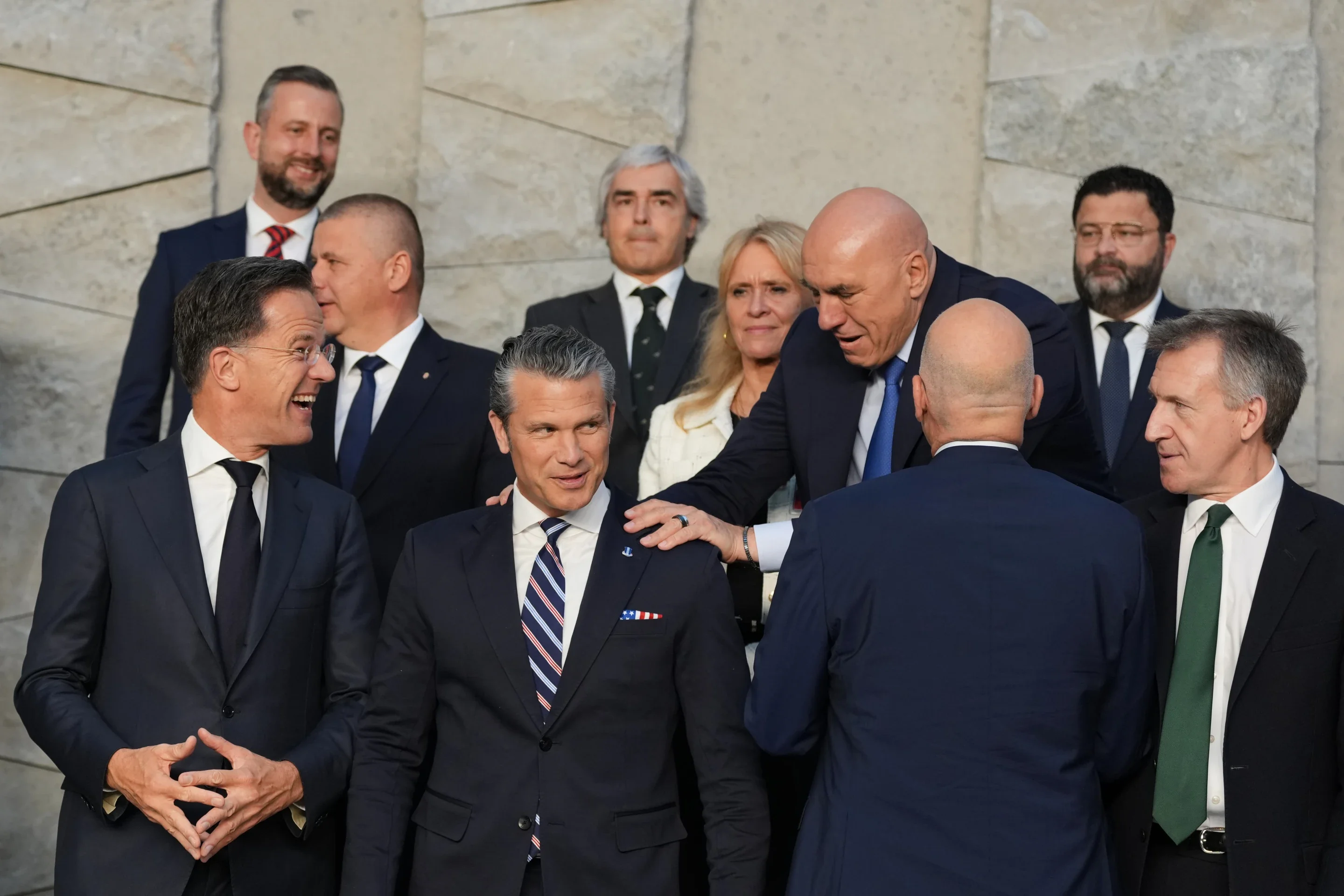 Italy’s Defense Minister Guido Crosetto, fourth right, greets United States Defense Secretary Pete Hegseth, front second left, during a group photo of NATO defense ministers at NATO headquarters in Brussels, Thursday, June 18, 2026. (AP Photo/Virginia Mayo)