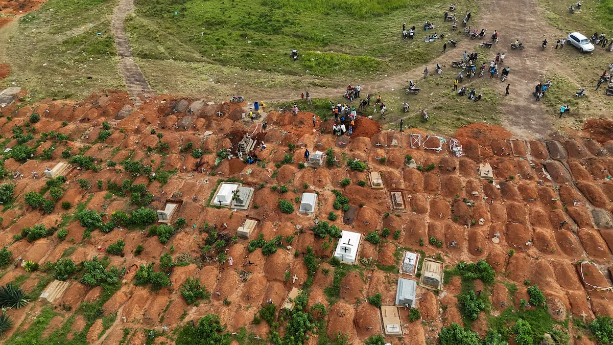 A drone view of displaced people from the Kigonze camp attending the burial of Ebola victims at Nyamurongo Cemetery, one month after an outbreak was declared, in Bunia, eastern Democratic Republic of Congo, June 18, 2026. REUTERS/Gradel Muyisa Mumbere Purchase Licensing Rights