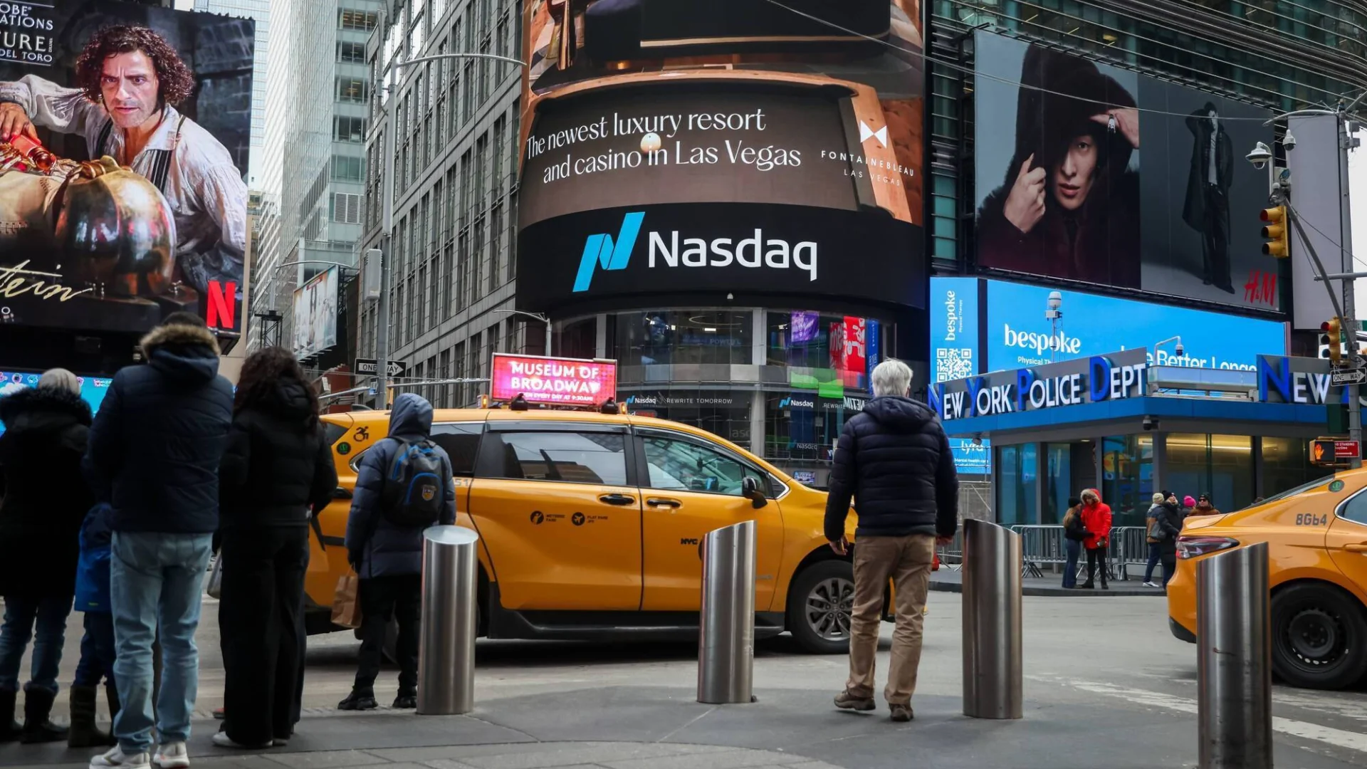 The heartbeat of NYC: A bustling afternoon at Times Square with the iconic Nasdaq MarketSite in full view.