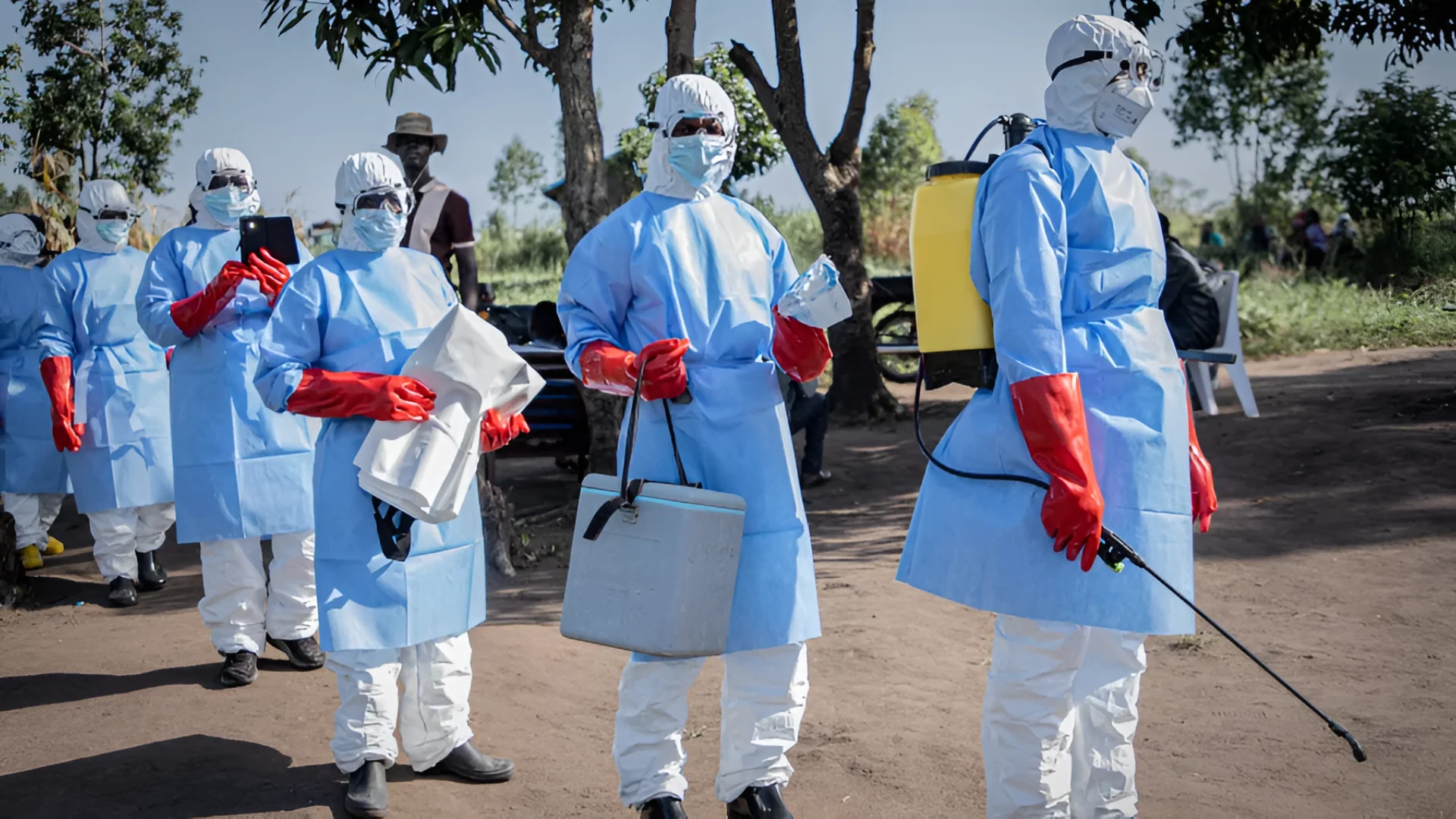 Volunteers wearing personal protective equipment prepare to recover the body of a 3-year-old child presumed dead from Ebola in Bunia, DRC.  Benediction Murhabazi/AFP via Getty Images