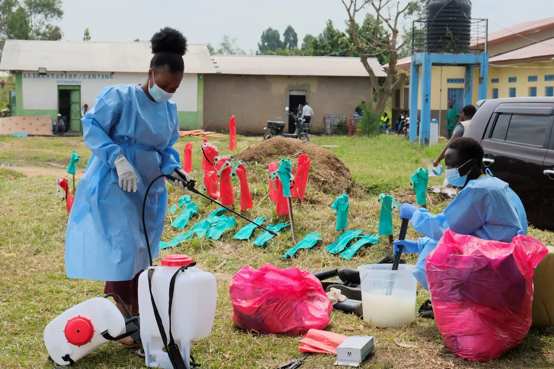 Medical workers dressed in personal protective equipment (PPE) disinfect their equipment at an Ebola treatment centre during a ceremony to present recovery certificates to patients at the Rwambara General Reference Hospital in Bunia, eastern Democratic Republic of Congo, June 16, 2026. REUTERS/Gradel Muyisa Mumbere/File Photo Purchase Licensing Rights