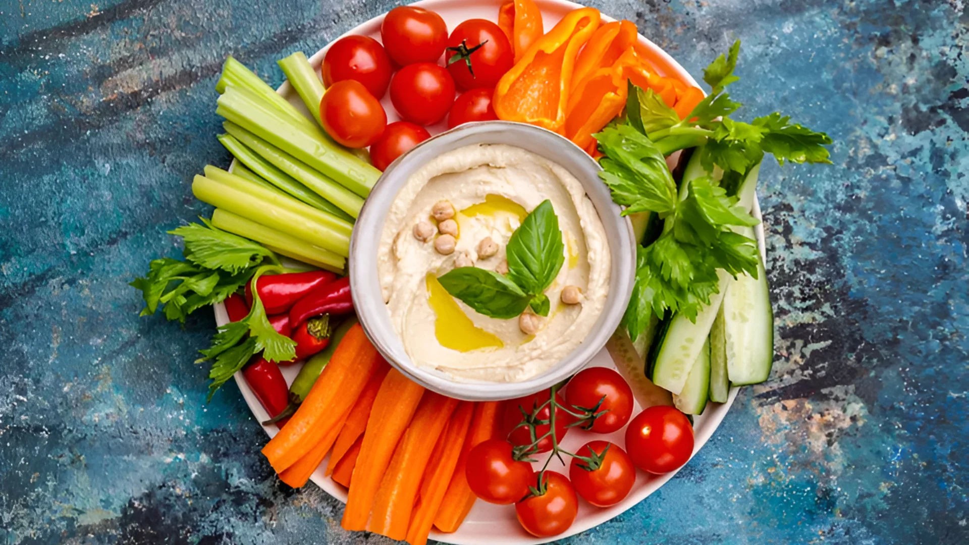 Savory snacks like hummus, edamame, cottage cheese, and whole-grain crackers can support fullness. Roxiller / Getty Imag