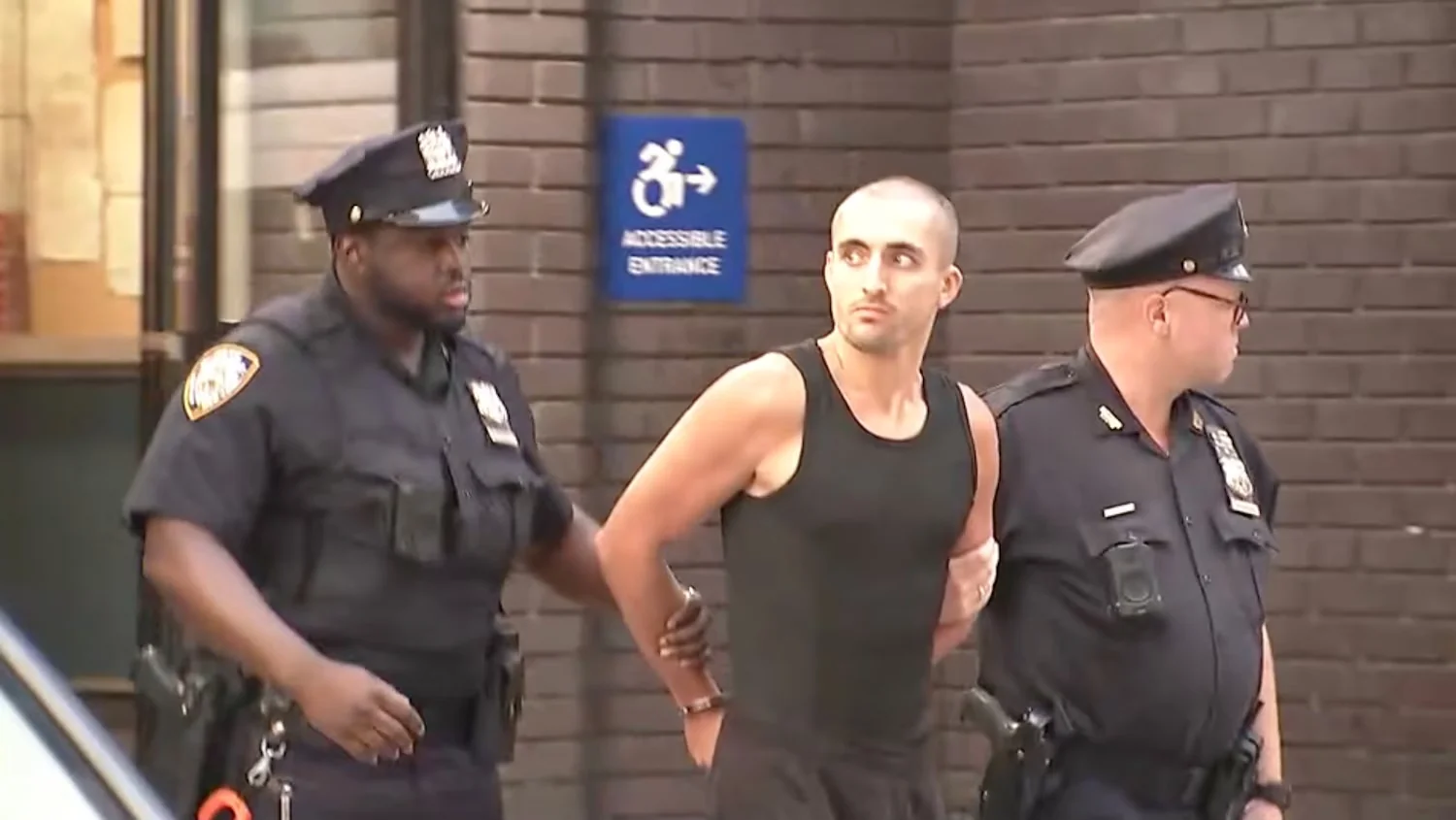 Ivan Kuznetsov, who is also known as Ivan Beerkus, is seen being escorted out of a Manhattan police station, July 1, 2026. WABC