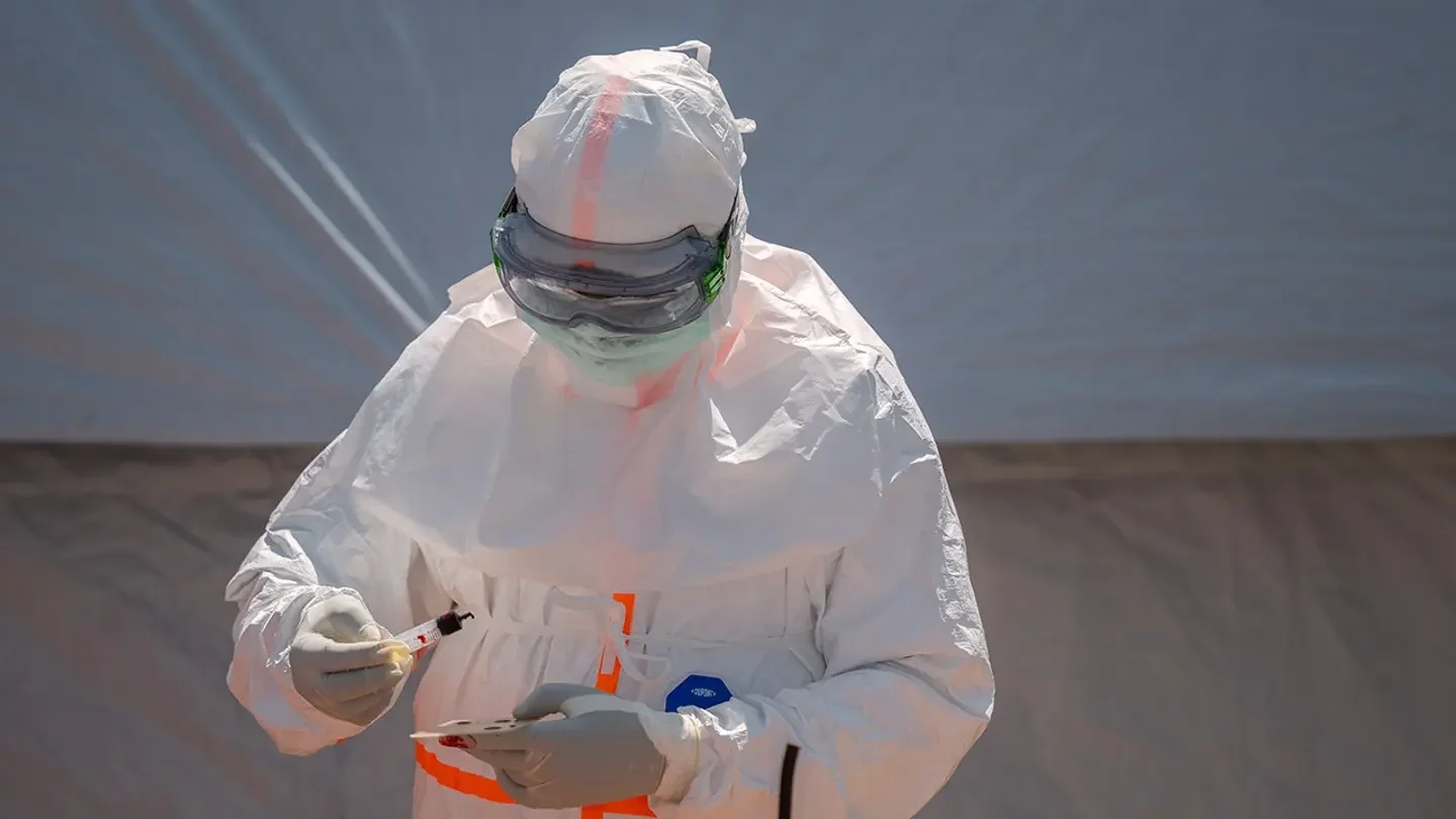 A health worker prepares a patient's blood sample for testing at Bunia General Hospital in Bunia, Congo, June 11. (Moses Sawasawa/AP Photo, File)