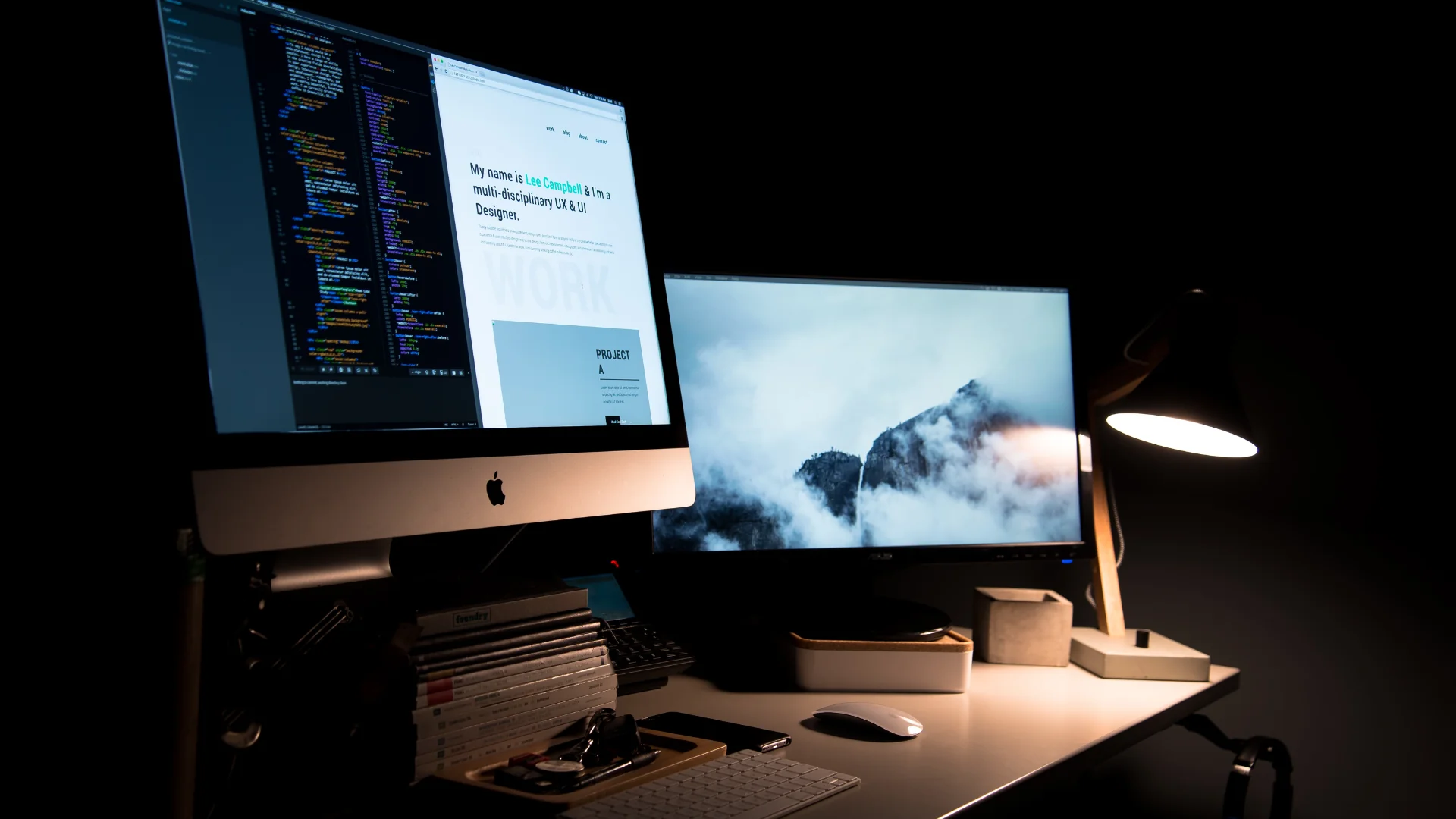 A clean and stylish workspace with two monitors, a lamp, and office supplies. Credit: Lee Campbell
