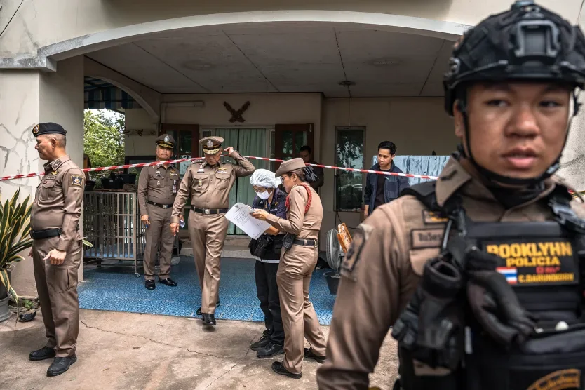 Police gather outside the house where a teenager is suspected of killing his grandparents before carrying out a school shooting in Thailand on August 7 Chanakarn Laosarakham/AFP/Getty Images