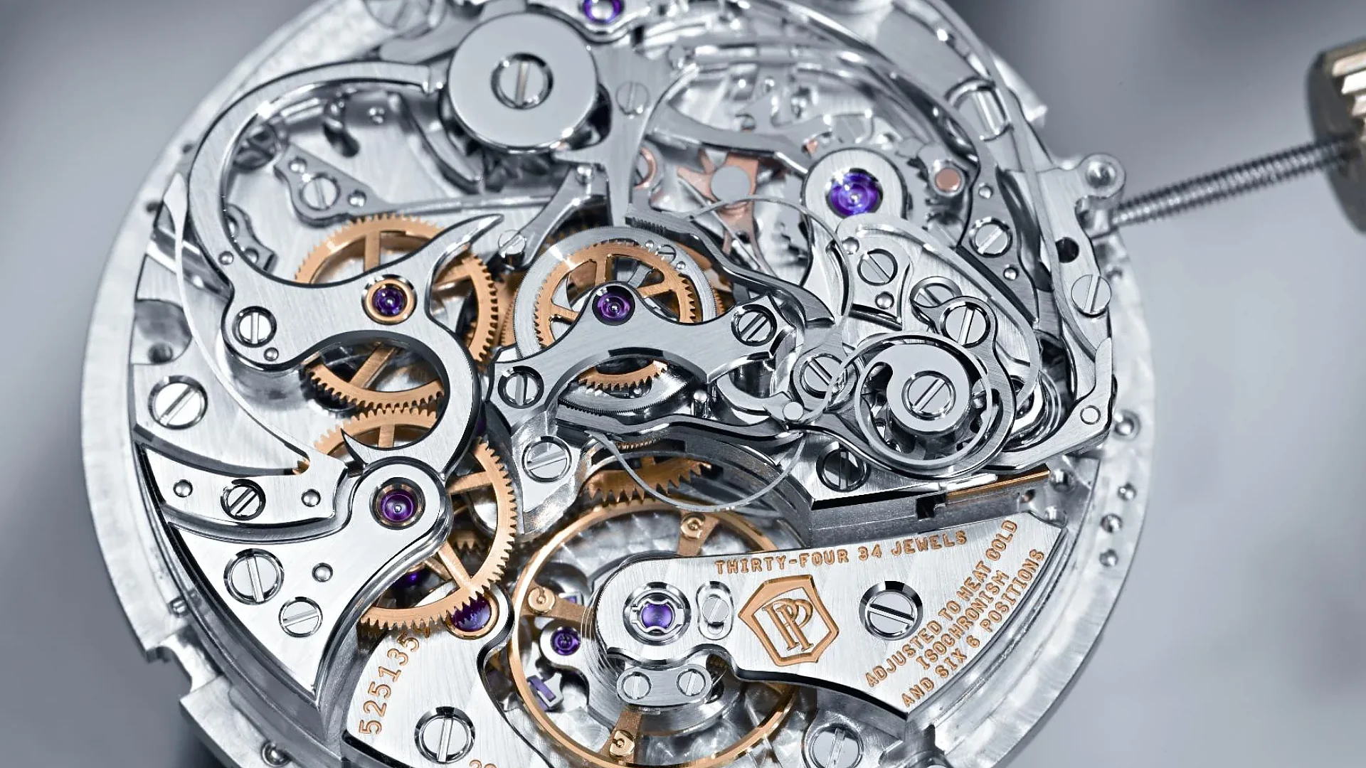 Intricate Patek Philippe Caliber CH 29-535 PS mechanical watch movement with visible gears and jewels.