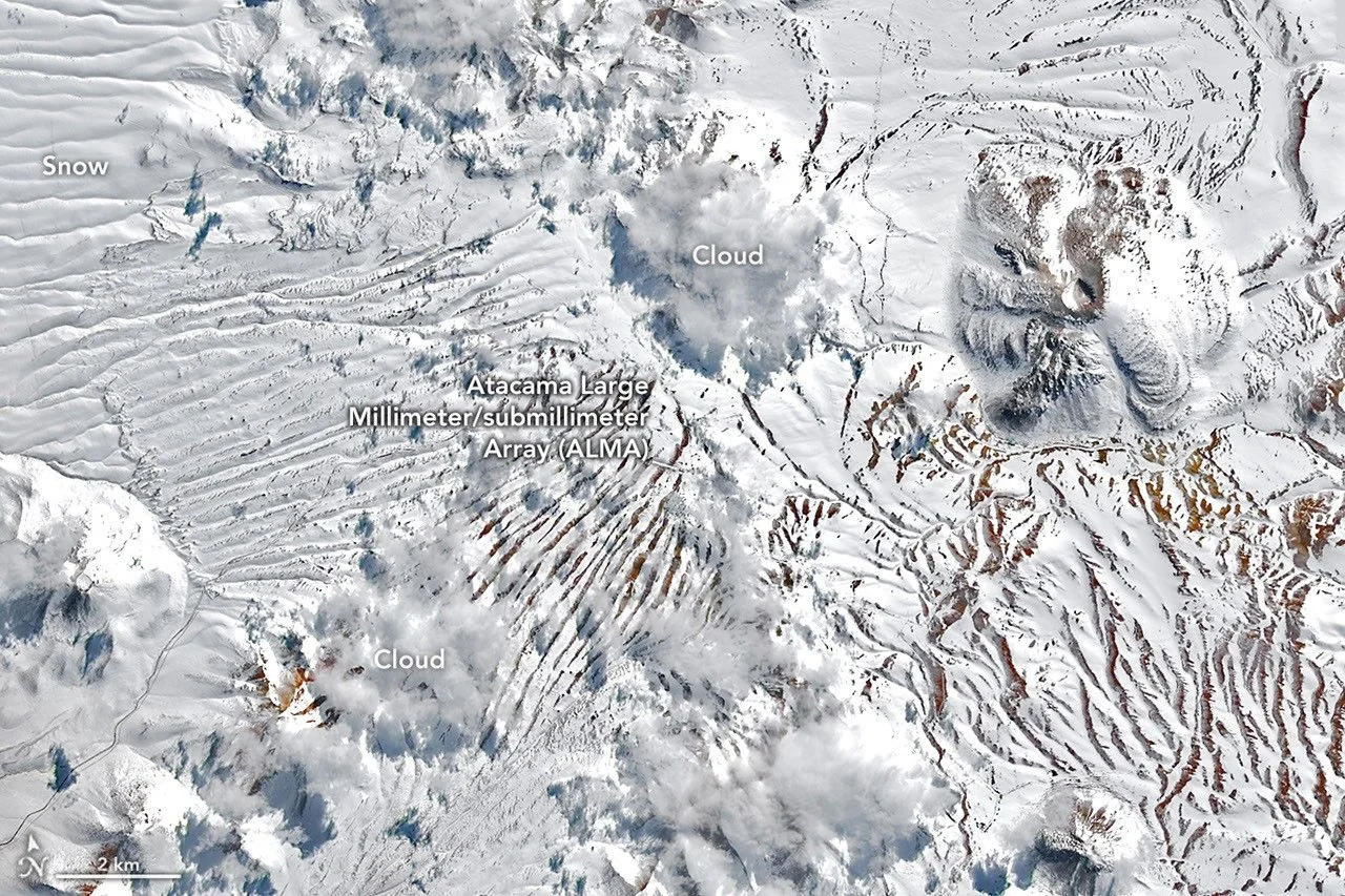 Satellite view of the Chajnantor Plateau in Chile's Atacama Desert on August 14, 2026, covered in rare snow following a storm, with the ALMA telescope site marked. Photo by: NASA Earth Observatory.