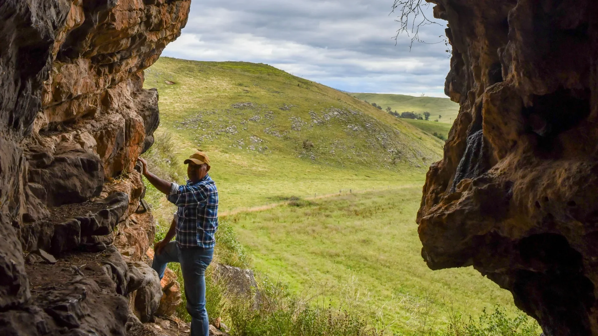 GunaiKurnai Elder Uncle Russell Mullett standing at the entrance of Cloggs Cave. Photo: Jess Shapiro, courtesy of GunaiK